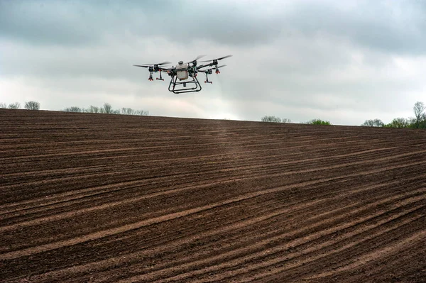 stock image spraying fields with drones, plowing agricultural fields, applying fertilizers with drones the possibility of processing after the rain