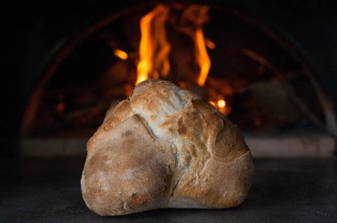Ev yapımı İtalyan ekmeği fırının arka planında alevli.