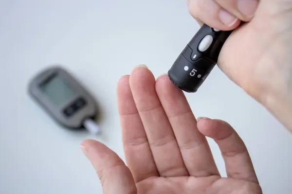 stock image Finger-prick blood sugar screening for diabetes test.