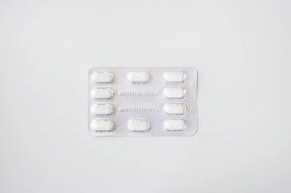 Beyaz arka planda izole edilmiş su toplayan beyaz tıbbi haplar. Kopya için alanı olan yatay pankart. Eczane, ilaç, tedavi kavramı