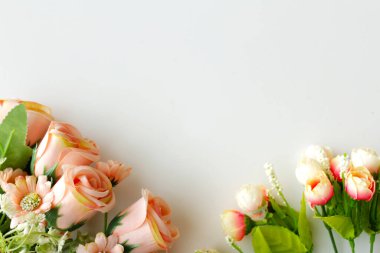 Romantik afiş için beyaz arka planda çiçekli çerçeve. Kopya alanı olan pastel renkli güller ve gül goncaları.