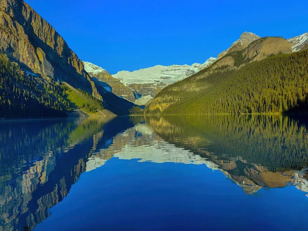 Mountains reflected in glacial lake, Moraine Lake, Banff National Park, Alberta, Canada.