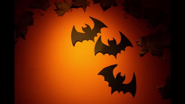 Time Lapse Paper Bats Moving Orange Background Falling Autumn Leaves — Stock Video