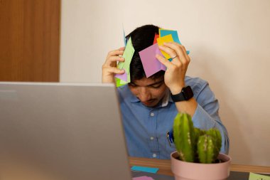 Man with a lot of work in his office desperate, concept of stress at work clipart