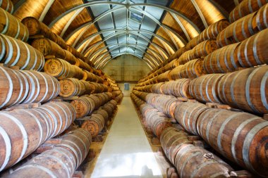 Le Francois, Martinique island , France - December 22, 2022 : Barrels with rum in Habitation Clement on Martinique. It located in the municipality of Le Francois. This rum earned an international reputation. clipart