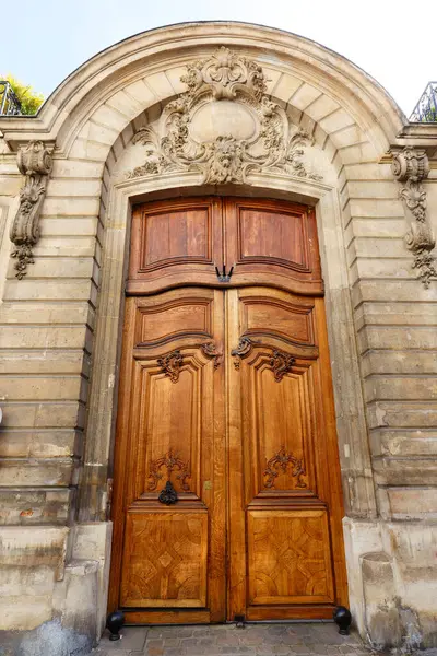 Old ornate door in Paris, France - typical old apartment building.