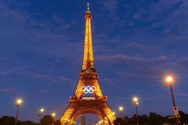 Paris, France-June 22, 2024 : The night view of Eiffel tower with Olympic rings of the Paris 2024 Olympic Games. it is the most visited monument in the world located in 7th district of Paris.