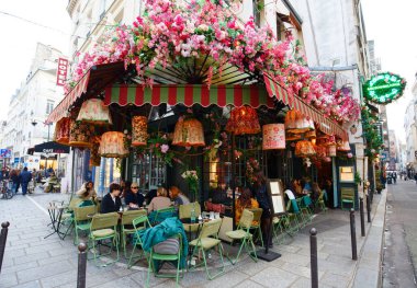 Paris, France- November 30 ,2024: The traditional cafe Maison Sauvage decorated with flowers located Saint German district of Paris . clipart