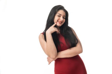 Portrait of cheerful laughing young woman in light clothing looking at camera, pointing hands to the side over white studio background. Sincere emotions of people, lifestyle concept.