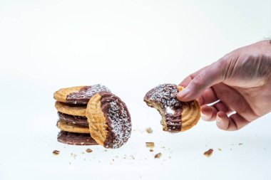 glass of milk with coffee and cookies for breakfast coconut and chocolate, bottle of milk white background with fallen coffee beans
