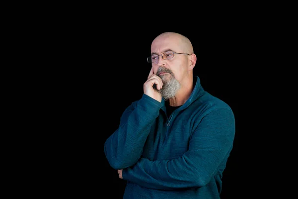 bald middle age man with goatee sick using headache medication and angry on black background