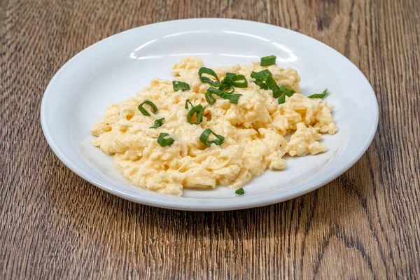 stock image scrambled eggs with fresh green onions.