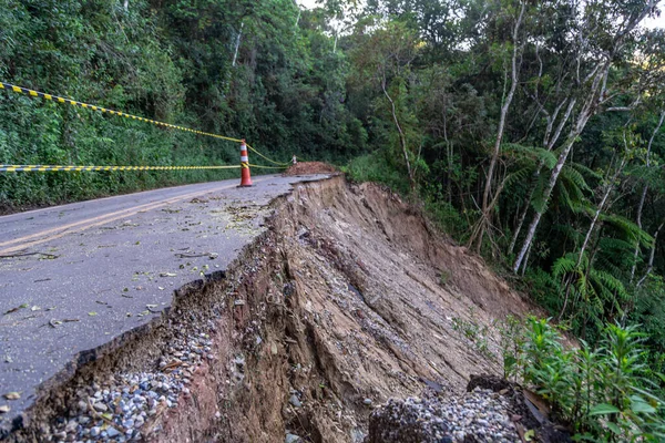 stock image asphalt road damaged by a landslide in a mountain area.