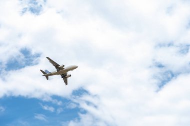 landing plane on blue sky with clouds. High quality photo