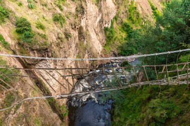 old suspension bridge over the chasm. High quality photo