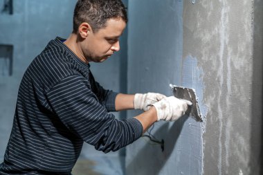 manual application of waterproofing to the wall on the construction site. 