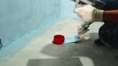 manual application of waterproofing to the wall on the construction site. 