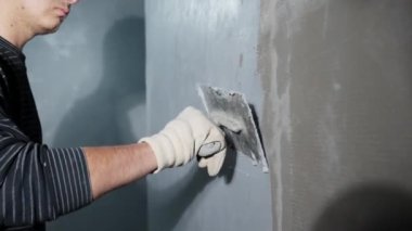 manual application of waterproofing to the wall on the construction site. 
