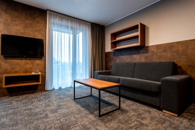 furniture in the hotel room, sofa set with coffee table and TV. High quality photo
