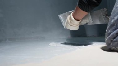 manual application of waterproofing to the floor on the construction site. 