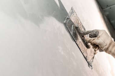 manual work with a trowel for waterproofing the wall. 