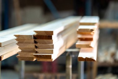 wooden boards on a rack in a carpentry shop. High quality photo