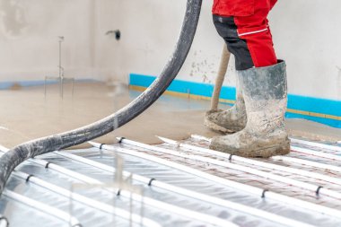 installation of concrete and anhydrite on underfloor heating in a room of a newly built family house. High quality photo