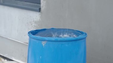 rainwater in a barrel in front of the house. 