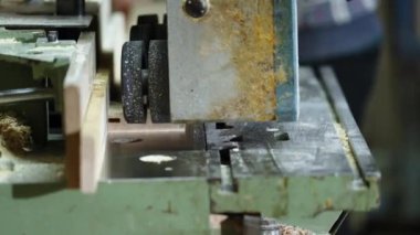 planing boards on a machine in a joinery. 