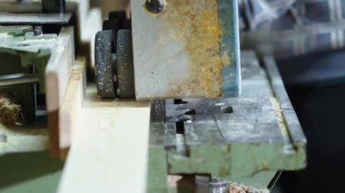planing boards on a machine in a joinery. 