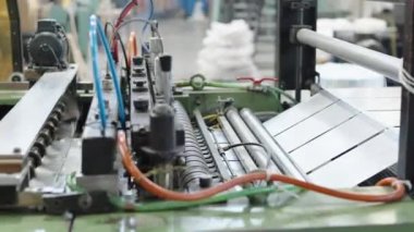 robotically automated machine for the production of plastic bags in a factory. High quality 4k footage