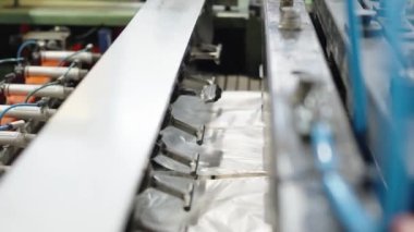 robotically automated machine for the production of plastic bags in a factory. High quality 4k footage