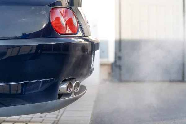 smoke from the exhaust of a car with a gasoline engine.