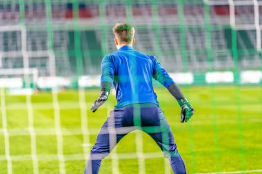 goalkeeper catches the ball in the goal in a soccer match. High quality photo