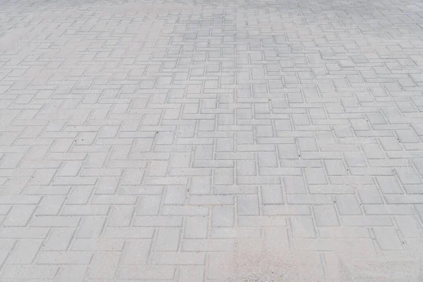 new sidewalk made of concrete interlocking paving blocks.