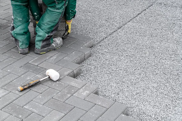 stock image construction of a sidewalk from concrete blocks. 