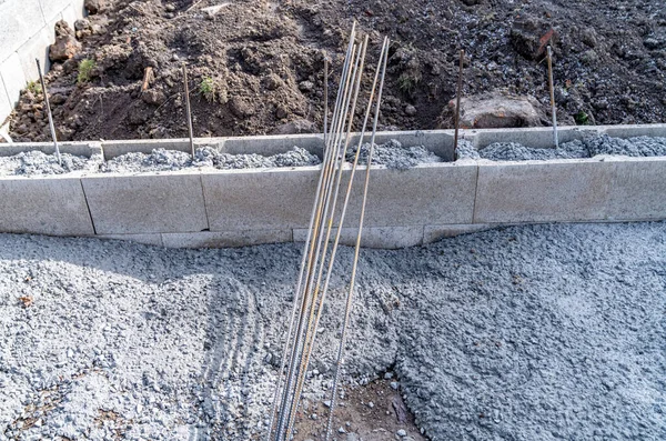 concrete foundation of the building with metal reinforcement.