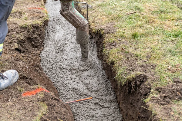 stock image concreting from the pipe of the cement mixing car. 