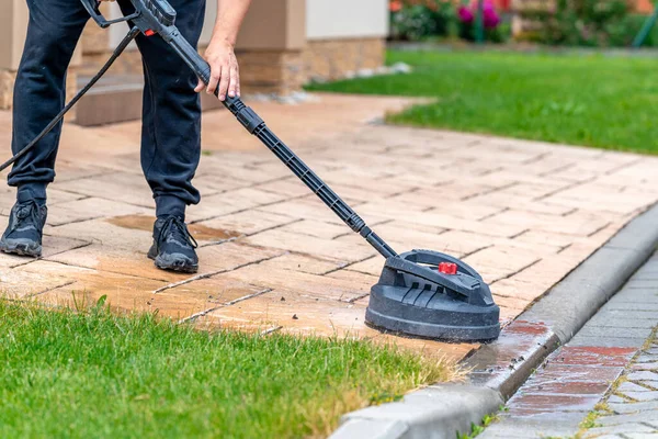 stock image machine cleaning concrete pavement in front of the house with a brush. High quality photo