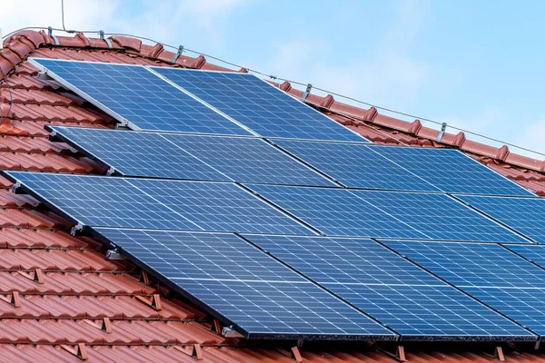 solar panels on the roof of the house to produce energy from sunlight. High quality photo