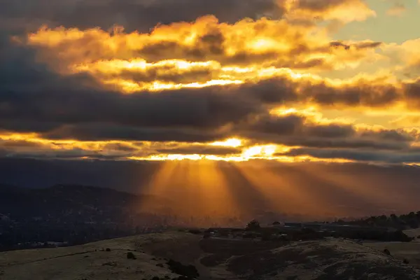 stock image Sun setting and beaming through clouds at Santa Teresa County Park, Santa Clara County, California.