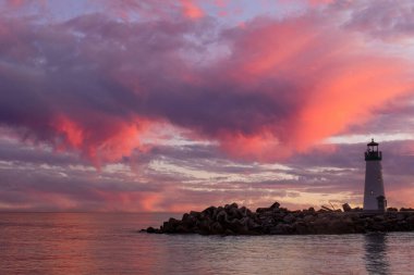 Vibrant twilight skies over Breakwater (Walton) Lighthouse via Seabright Beach. Santa Cruz, California, USA. clipart