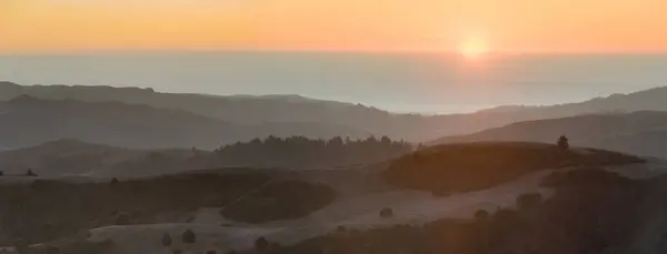 stock image Sun Setting over Rolling Landscape and the Pacific Ocean via La Honda Creek Open Space Preserve, San Mateo County, California.