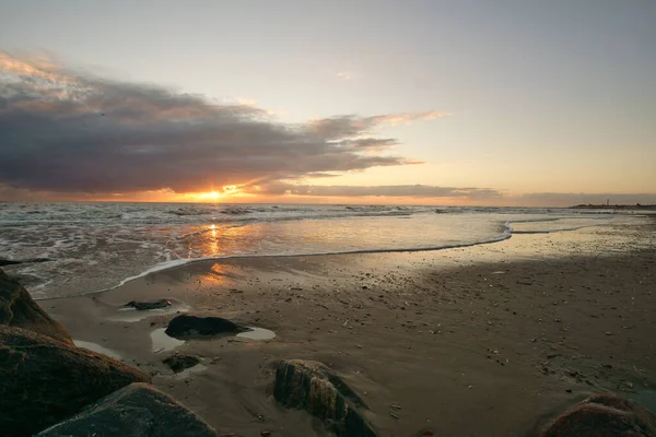 デンマークのビーチで日没 手前の石 砂の中の海岸を歩く 海の風景写真 — ストック写真