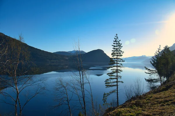 Stock image View of Oppstrynsvatnet lake in Norway in the morning hours. Snow covered mountains in the background. Calm water in mountain lake. Landscape shot from Scandinavia.