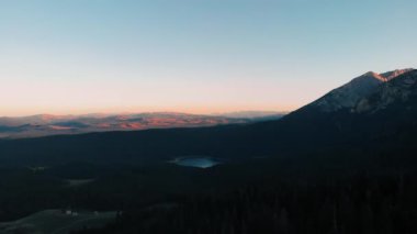Areal shot over the Durmitor national park.The last rays of the sun are reaching top of the mountains.Beatiful scenery in the Montenegro.4k drone shot of the forest and landscape of the national park.