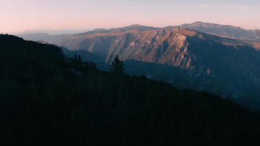 Areal shot over the Durmitor national park.The last rays of the sun are reaching top of the mountains.Beatiful scenery in the Montenegro.4k drone shot of the forest and landscape of the national park.