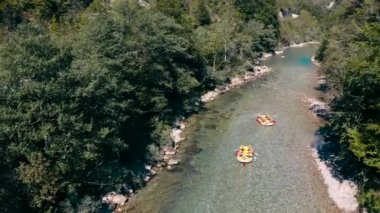 Tara river rafting.People are rafting the river on the boat.4k drone shot over the Tara river in Montenegro.Limpid fresh clean river water and rocks.Calm nature scenery of Montenegro and wild sport.