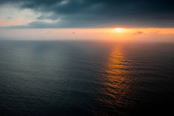 stock image drone view of the ocean and the sun hidden in the clouds