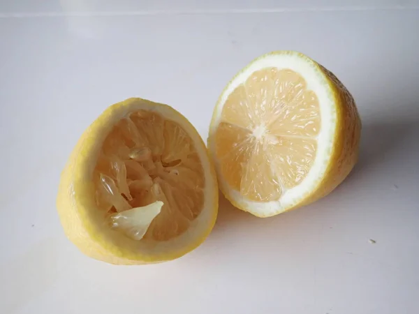 one lemon cut into halves on a table
